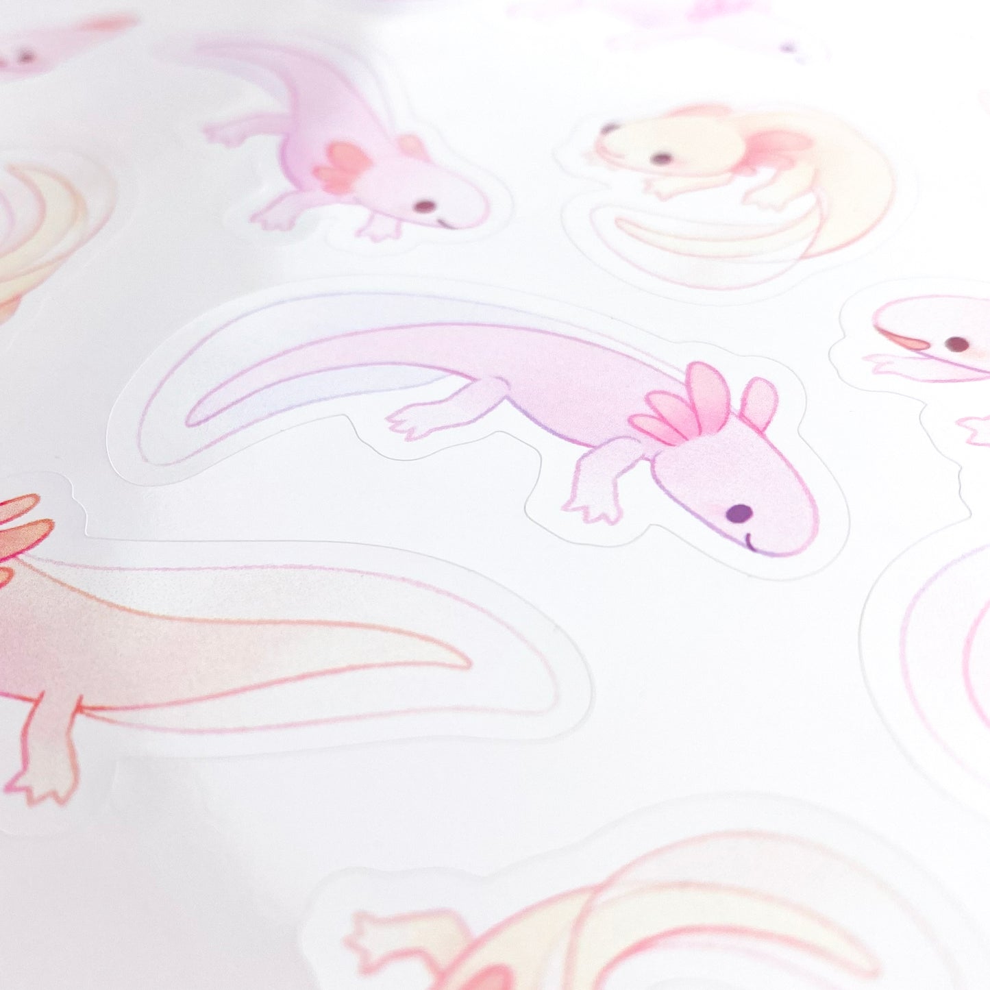A close-up of the sheet, showing the texture of the glossy vinyl and the good print quality. The colours are pastel and remind of water colour paintings.