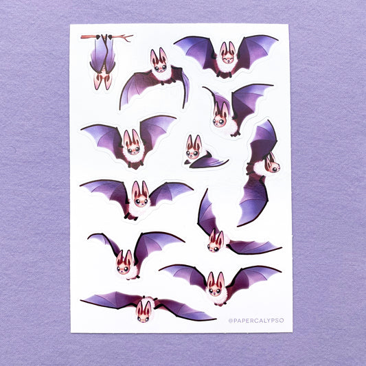 The bats have brown bodies with purple wings and a white fluffy body. Their ears are very large, since they are brown long-eared bats. The sticker sheet has 12 unique stickers printed on white glossy thin vinyl. This makes them sturdy and waterproof, but not too thick to use in a journal.