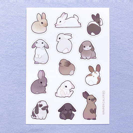 The bunnies have lots of different fur colours, from black to white, brown and spotted. They have cute little black eyes and a dark outline. The sticker sheet has thirteen unique stickers printed on white matte thin vinyl. This makes them sturdy and waterproof, but not too thick to use in a journal. Each sticker is an individual unique drawing of a bunny in a different pose.  They have been drawn sitting, loafing and standing up on their hind legs.