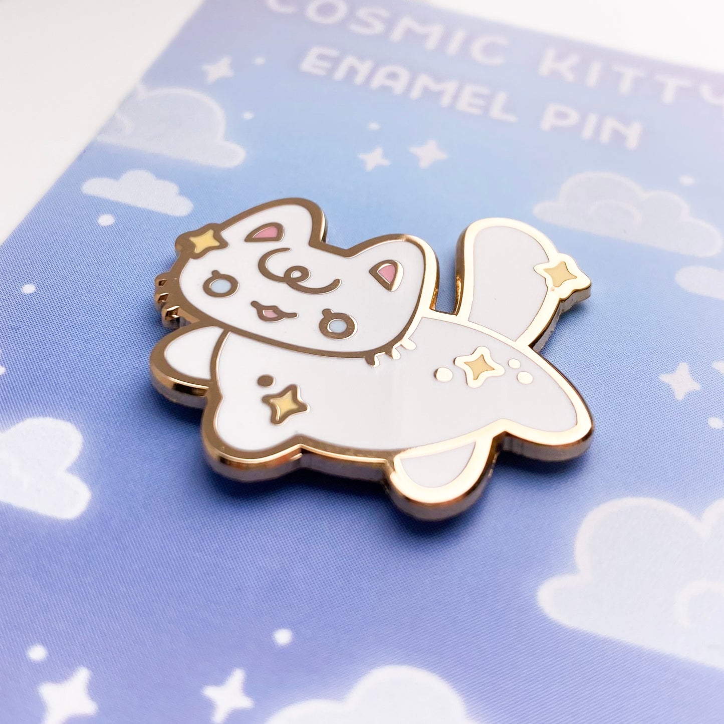 a close-up of the pin to better show the quality. The enamel is nice and smooth. The backing card is a magical pastel blue sky with stars and clouds.