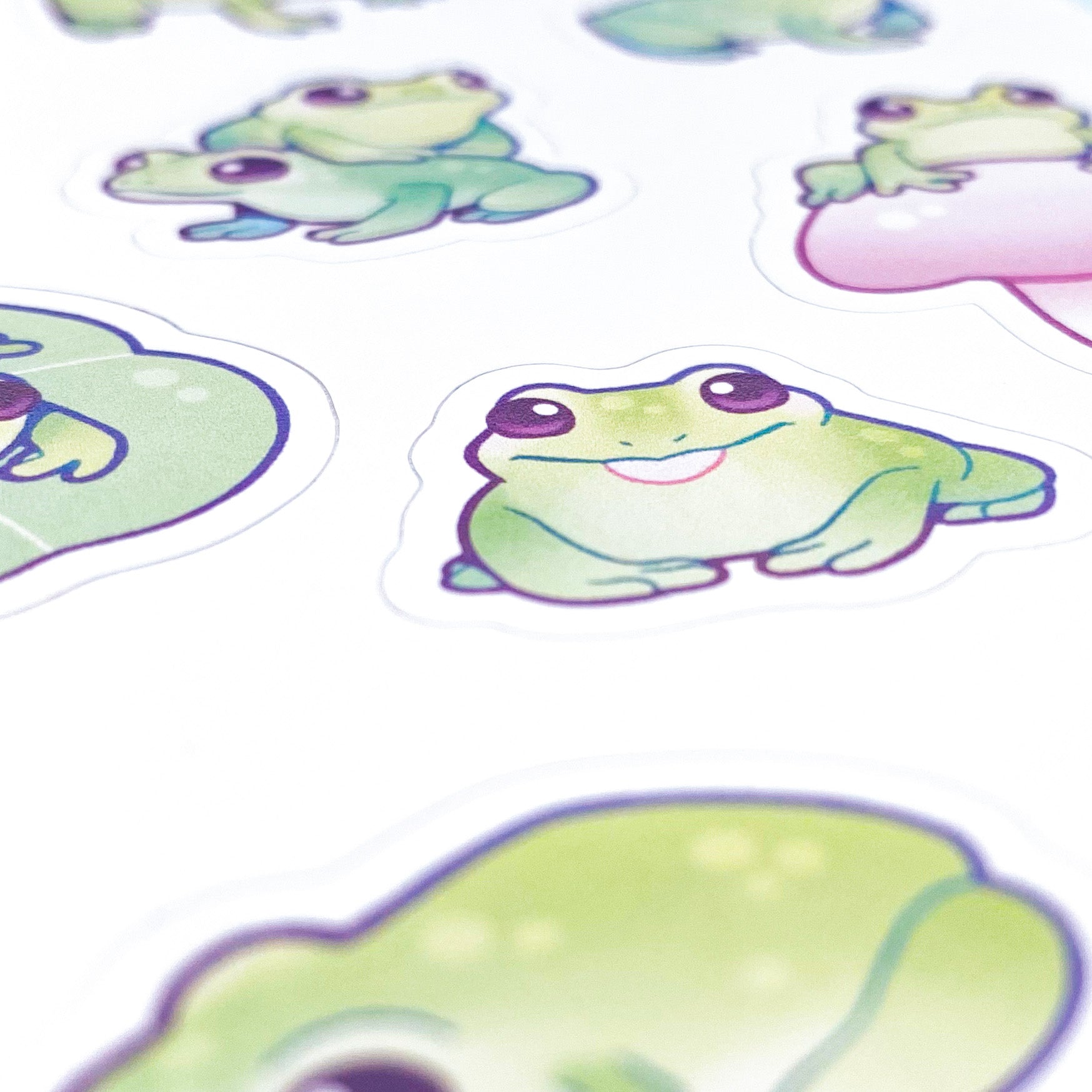 A close-up of the sheet, showing the texture of the matte vinyl and the good print quality. The frog in the picture is sticking out it's tongue and smiling.