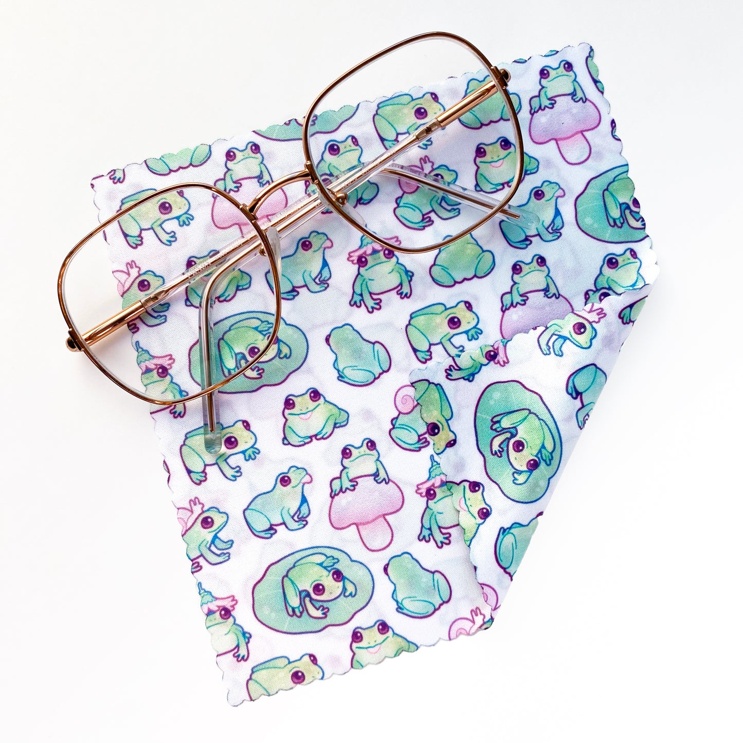 a pattern of cute green frogs on a micofibre cloth. For cleaning glasses, sunglasses, phone screens and camera lenses.