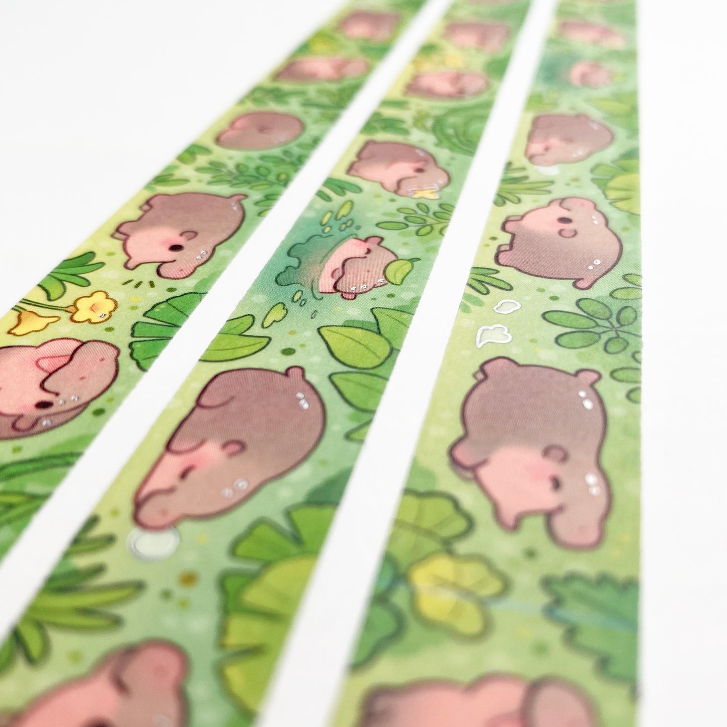 A different angle showing the holographic silver foil reflecting in the light. The foil is used to make the hippos look shiny and moist.