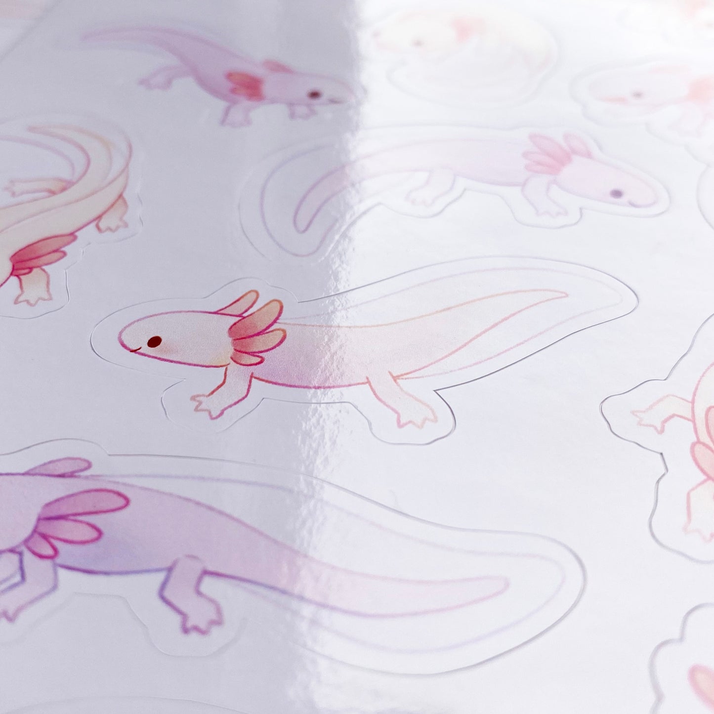 A close-up of the sheet, showing the texture of the glossy vinyl and the good print quality. The colours are pastel and remind of water colour paintings.