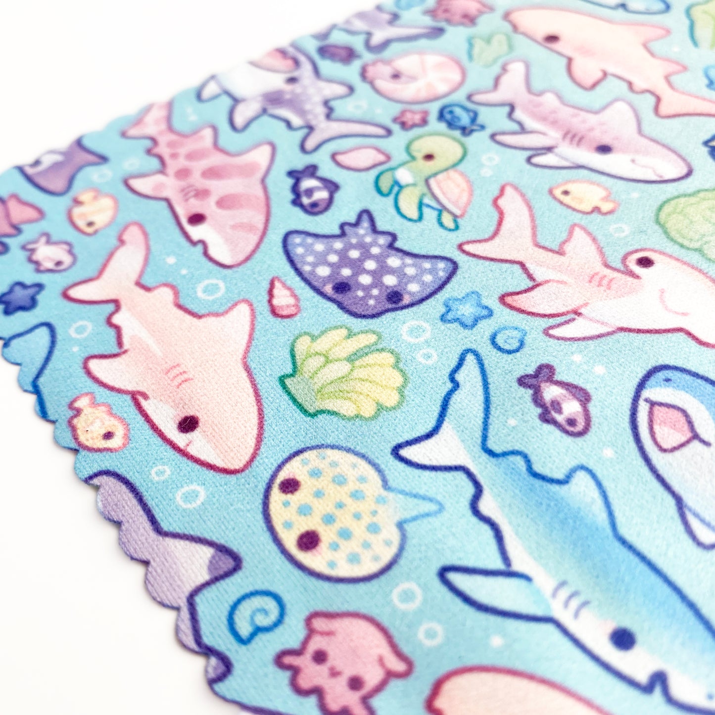 lots of fishes and sea plants like anemones are on the pattern too! The background is a pretty pastel blue turquoise.
