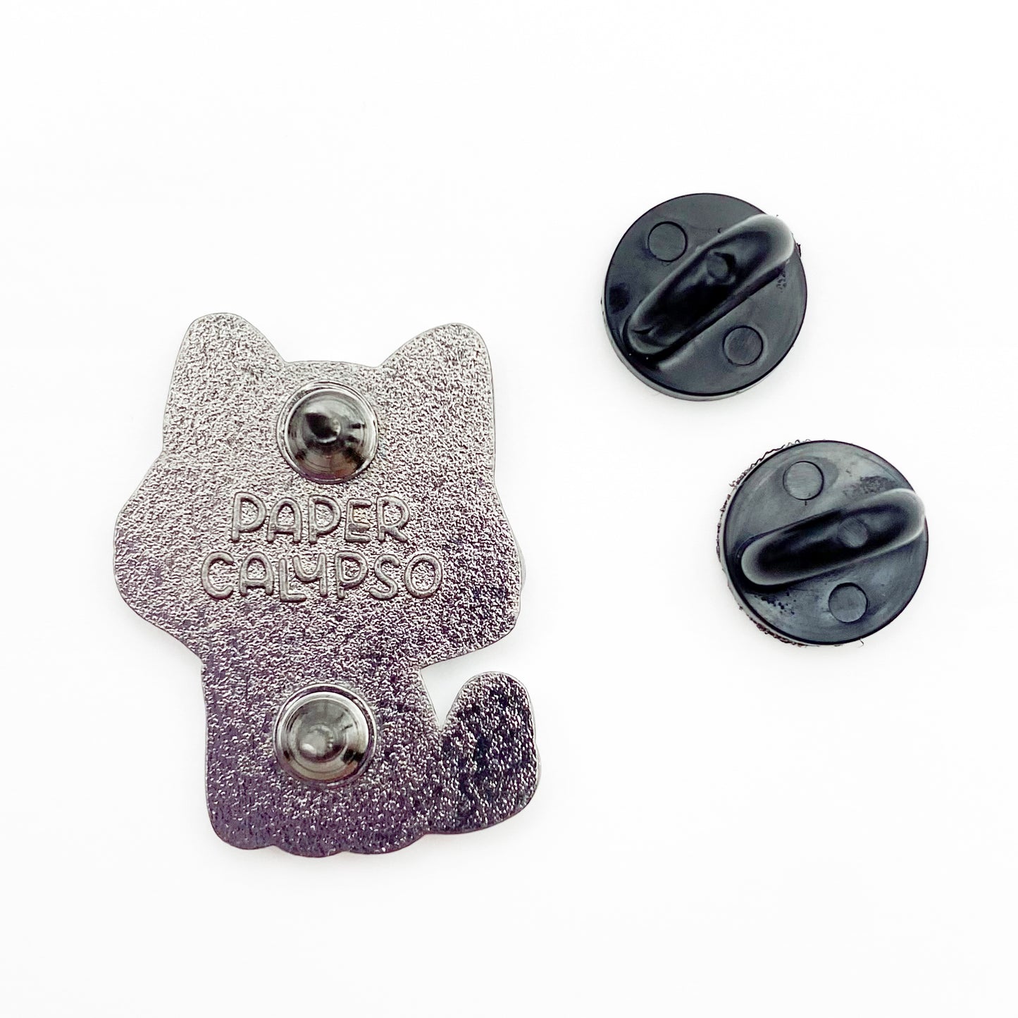 there are two pins on the back for extra security! This way you won't lose your pin if you put it on your clothes or bag. It comes with black rubber clasps. The back of the pin has a stamp with my watermark and reads "Paper Calypso"