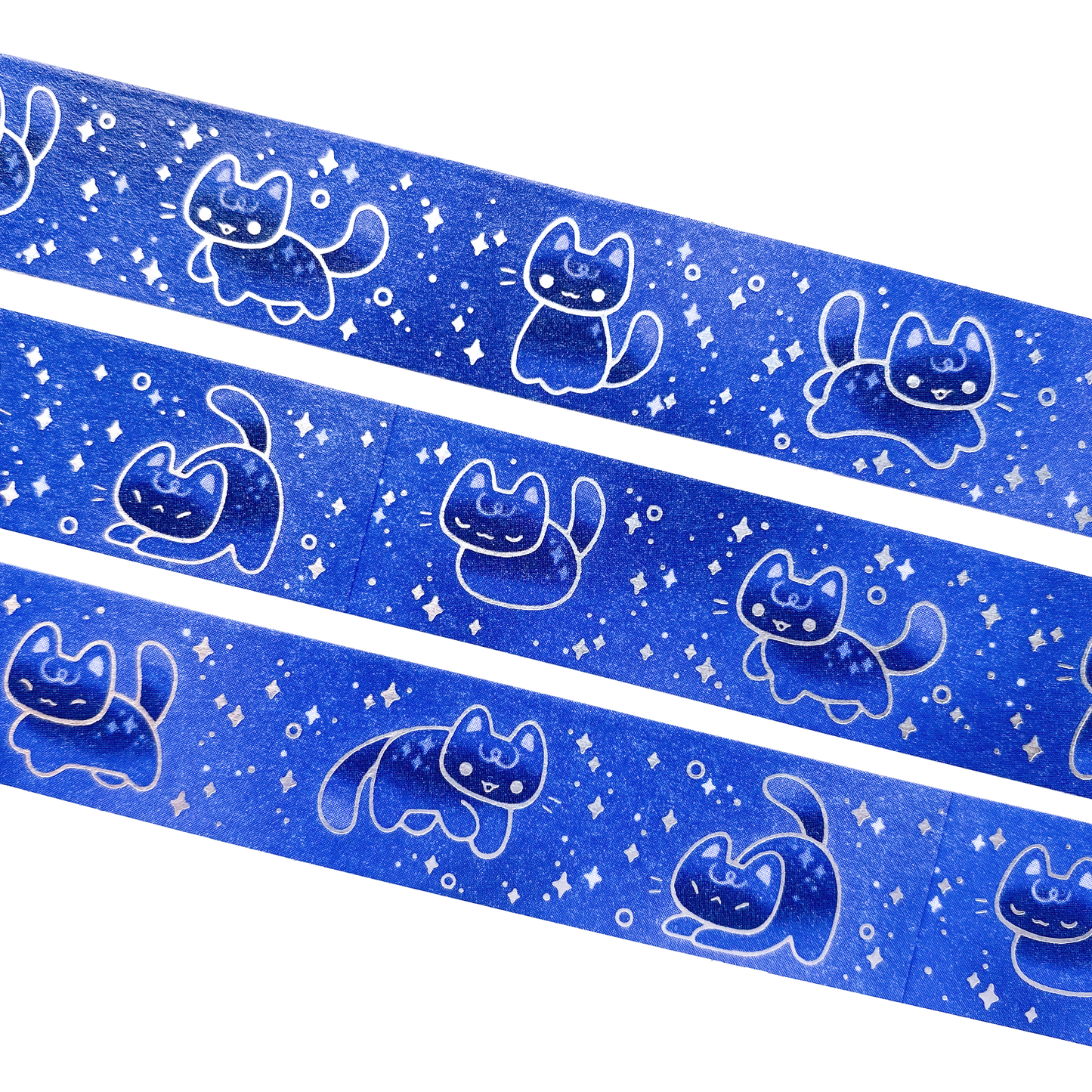 A close-up of the washi tape. The cats are magical beings, glowing in the dark. They are surrounded by silver foil stars.