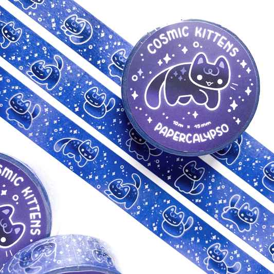 The roll of washi tape is packaged with shrink wrap plastic and a round sticker on one side. On it is an adorable kitten in the middle of a jump, happily smiling. It reads "Cosmic Kittens, 10 metres by 15 milimetres, by Papercalypso"