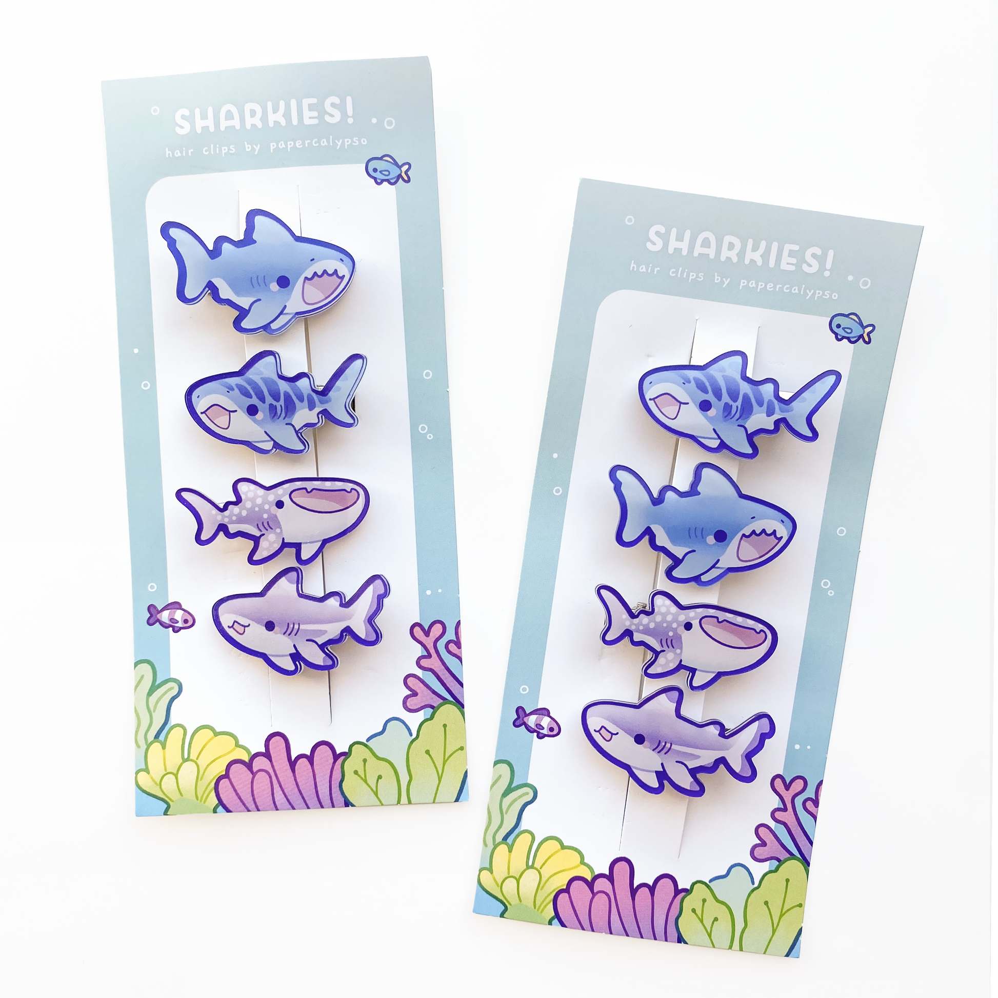 four cute shark hairclips a tiger shark, a great white, a whale shark and a black-tipped reef shark! One purple and one blue set. 