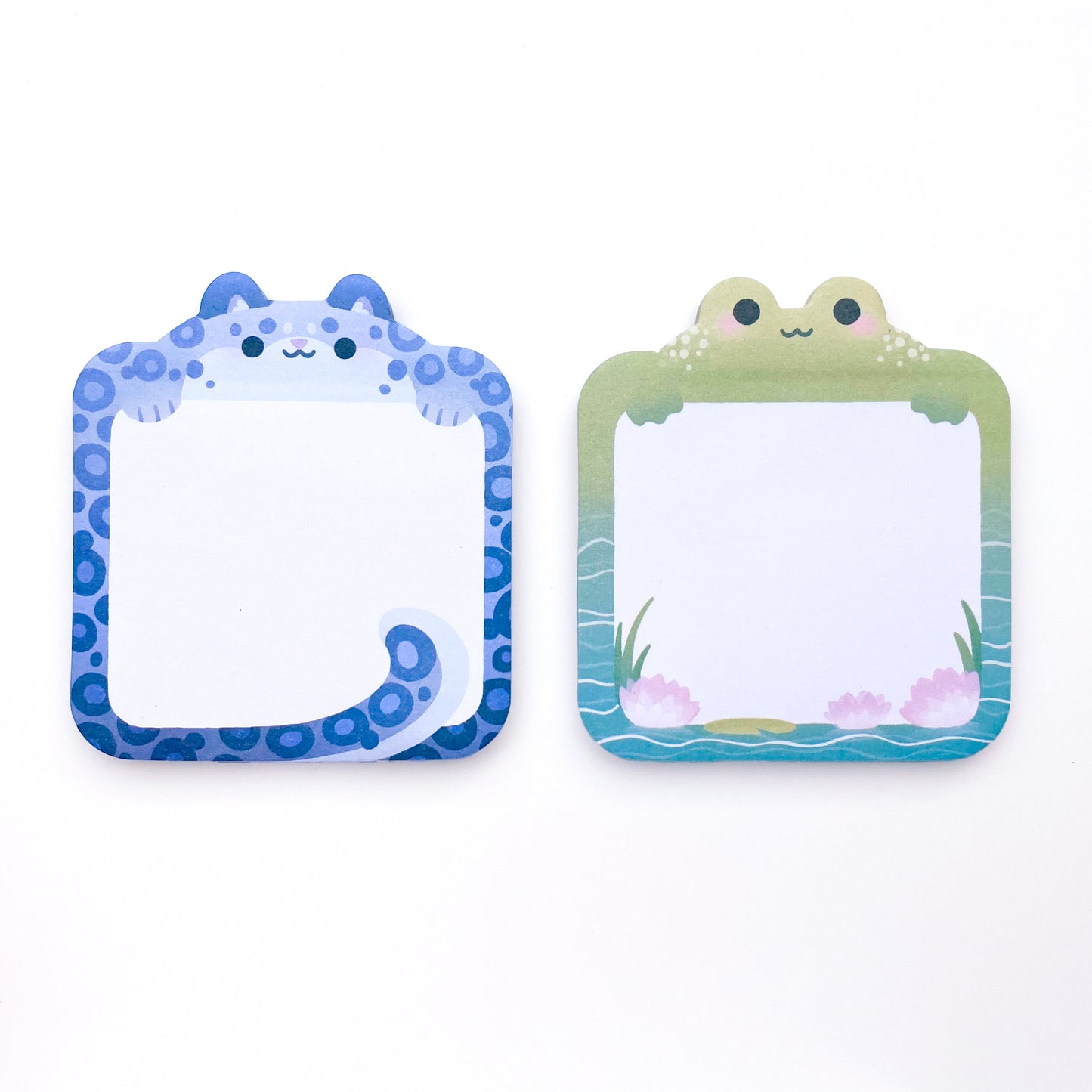 there are two types of sticky notes, one is frog themed and the other is snow leopard themed. They are rounded squares and the animal is poking out the top. The frog memo pad has water, a lily pad and water lilies. The snow leopard has spots all around and cute chunky round paws. Its fluffy tail wraps around the bottom of the white square for note taking.