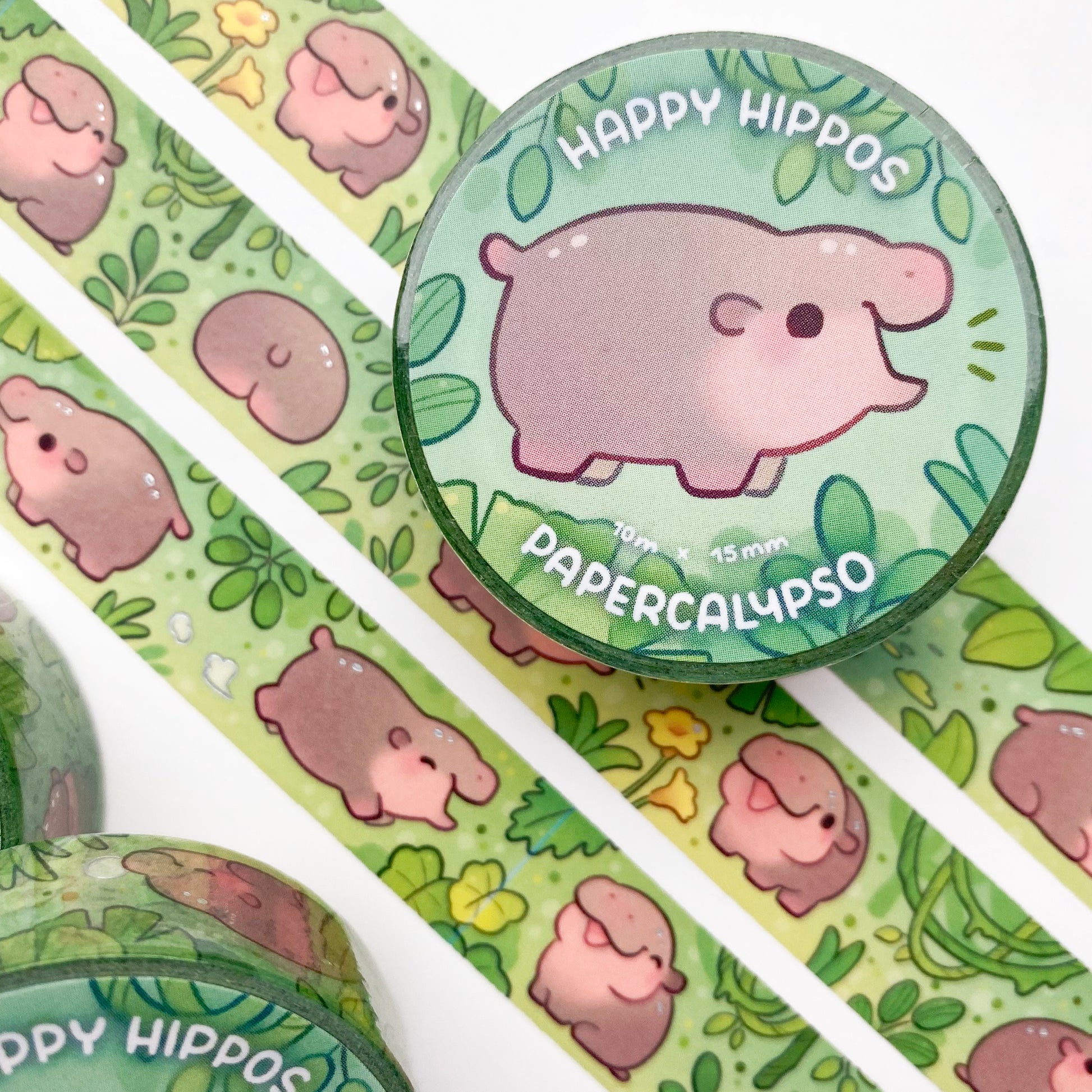 kawaii hippo themed washi tape featuring a jungle full of baby hippos. The hippos are shiny and round, happily living in the lush green foliage!