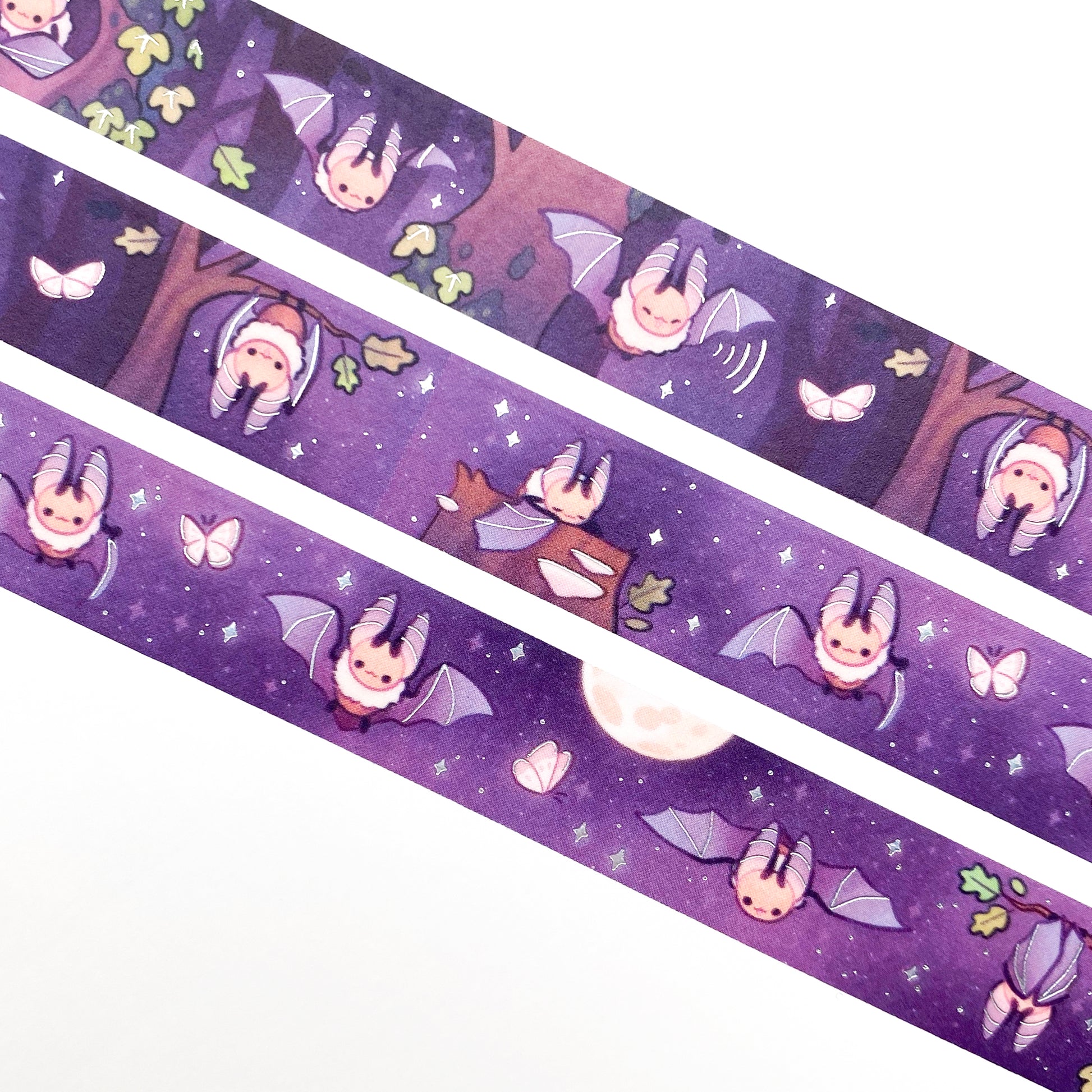 A close-up of the washi tape. The bats are surrounded by stars, moths and a dark oak forest. One is hanging upside down from a branch and another is sleeping on a mushroom-covered tree stump.