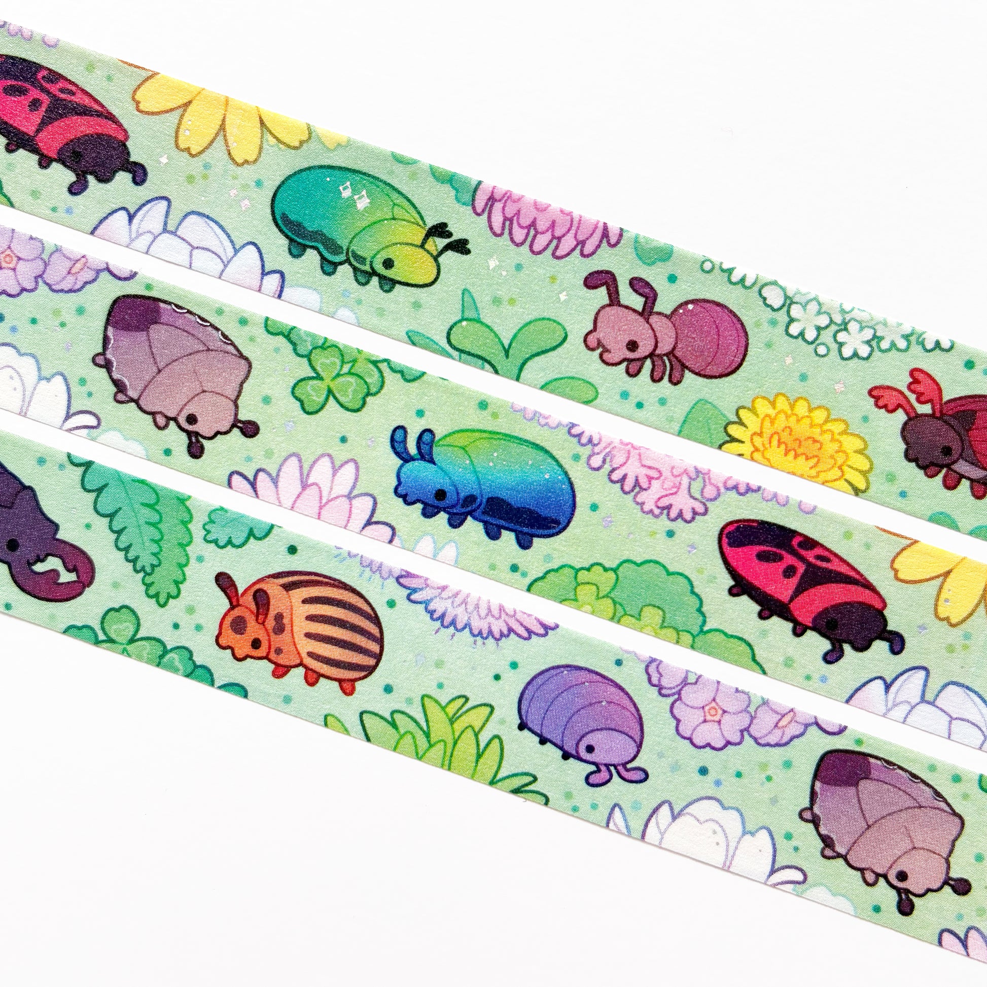 A close-up of the washi tape. The bugs are crawling around on a light green background. 
On the tape you'll be able to spot the rose beetle, ant, maybug (cockchafer), stinkbug, firebug, pill-bug (roly-poly), potato beetle, stag beetle and mint beetle.