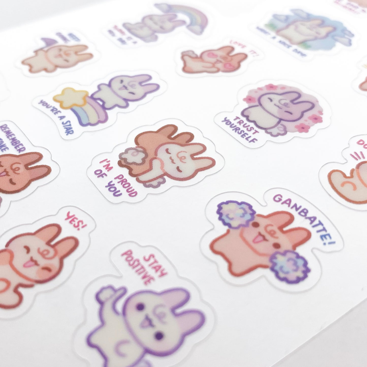 a close-up of the stickers to show the good print quality. In the middle are two bunnies hugging with the text "I'm proud of you". Other examples are "You're a star", "Ganbatte!" and "Trust Yourself".