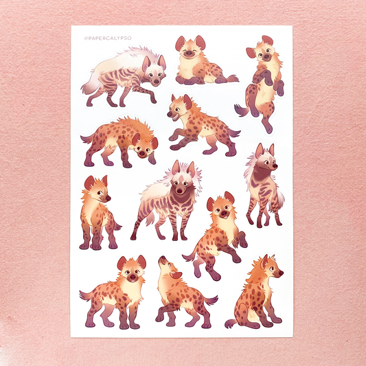 The hyenas are in warm pastel colours with some pink, yellow and orange touches. There's a mix of striped hyenas and spotted hyenas, from Africa. The sticker sheet has 12 unique stickers printed on white glossy thin vinyl. This makes them sturdy and waterproof, but not too thick to use in a journal.