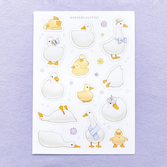 The sticker sheet has yellow baby ducks and grown up white ducks. The line art is thin and light, and the colours are pastel. The sticker sheet has thirteen unique duckling stickers, as well as six smaller flower stickers printed on white matte thin vinyl. This makes them sturdy and waterproof, but not too thick to use in a journal.