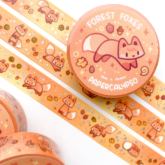 kawaii fox themed washi tape featuring green cartoon foxes on an orange background autumn foliage. These vulpines are jumping around like foxes do while hunting!