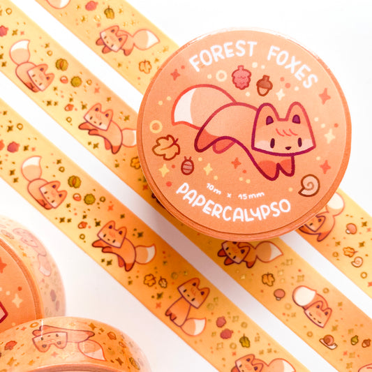 kawaii fox themed washi tape featuring green cartoon foxes on an orange background autumn foliage. These vulpines are jumping around like foxes do while hunting!