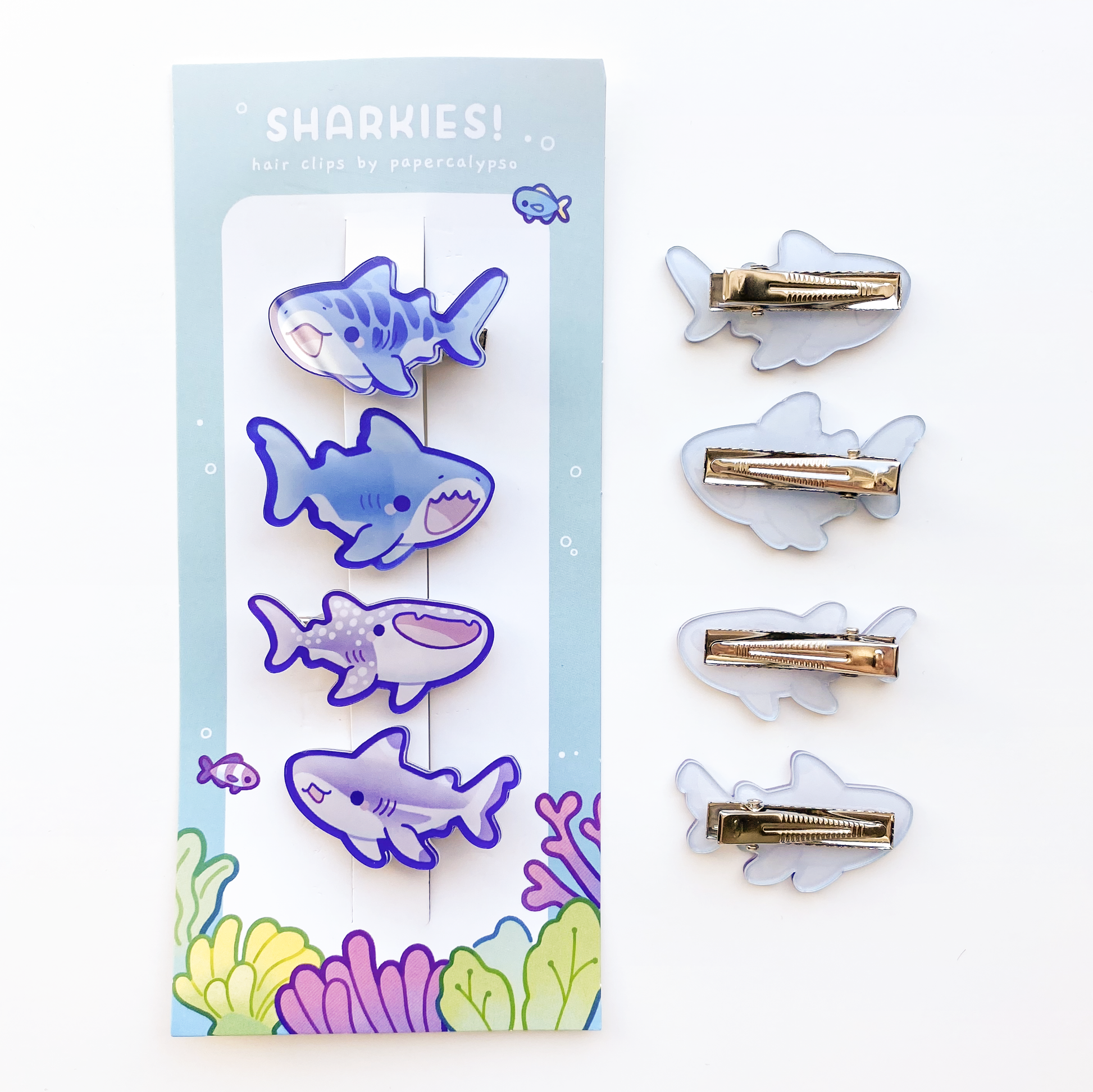 the sharks face away from the face when in your hair. They're presented on a cute coral reef themed backing card.