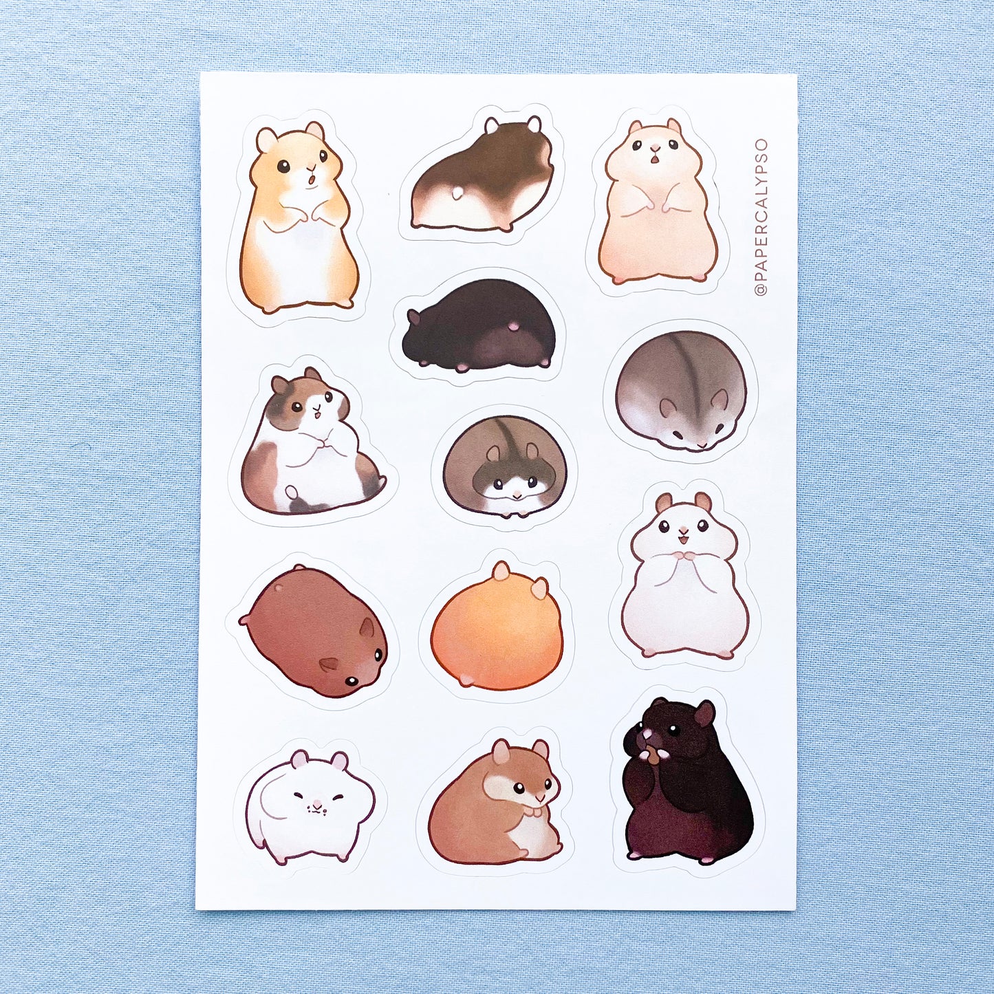 The hamsters are all different colours, from brown to ginger to black or white. They are very pudgy and round, many of them have fully stuffed cheeks. Their hands are very small and stubby. The sticker sheet has thirteen unique stickers printed on white matte thin vinyl. This makes them sturdy and waterproof, but not too thick to use in a journal.