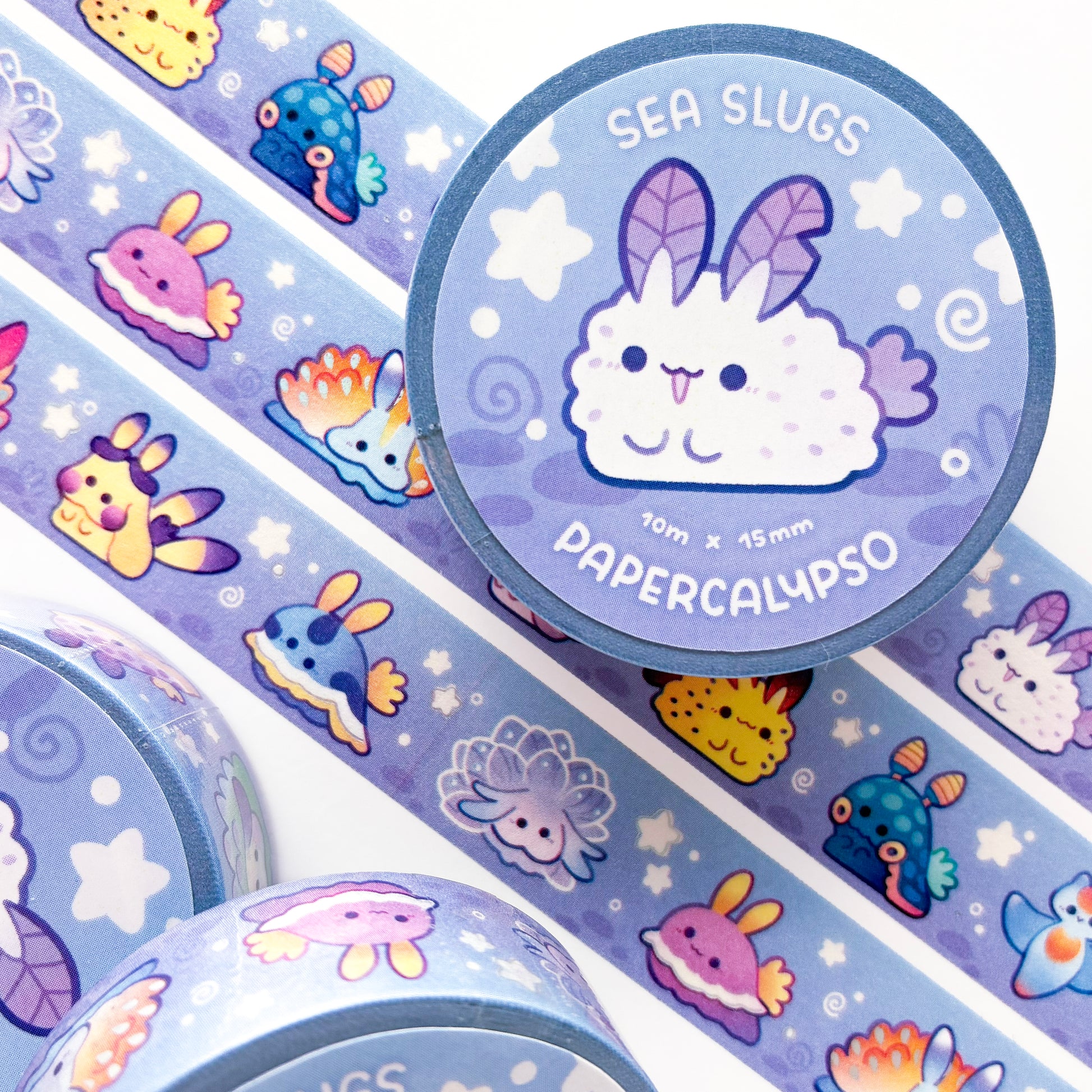 kawaii cartoon sea slug-themed washi tape featuring many different kinds of nudibranchs on an abstract purple background with stars and swirls. 