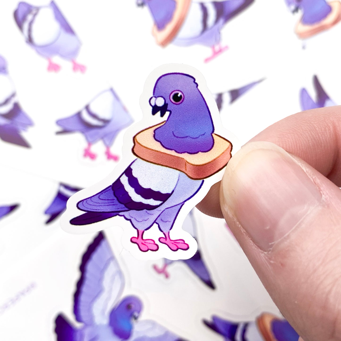 A sticker of a pigeon posing proudly with a piece of bread around its neck. The poses are funny and silly, two are wearing white toast while another has a pink bowtie, two others are grooming themselves. If you like urban wildlife these humorous birds are for you!