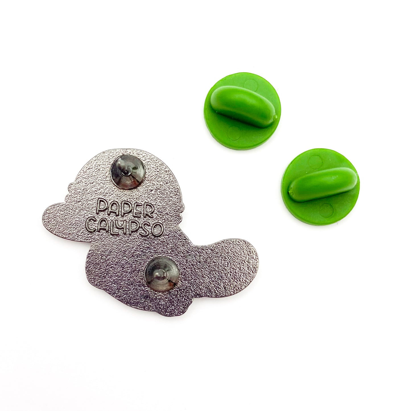 there are two pins on the back for extra security! This way you won't lose your pin if you put it on your clothes or bag. It comes with green colored rubber clasps. The back of the pin has a stamp with my watermark and reads "Paper Calypso"