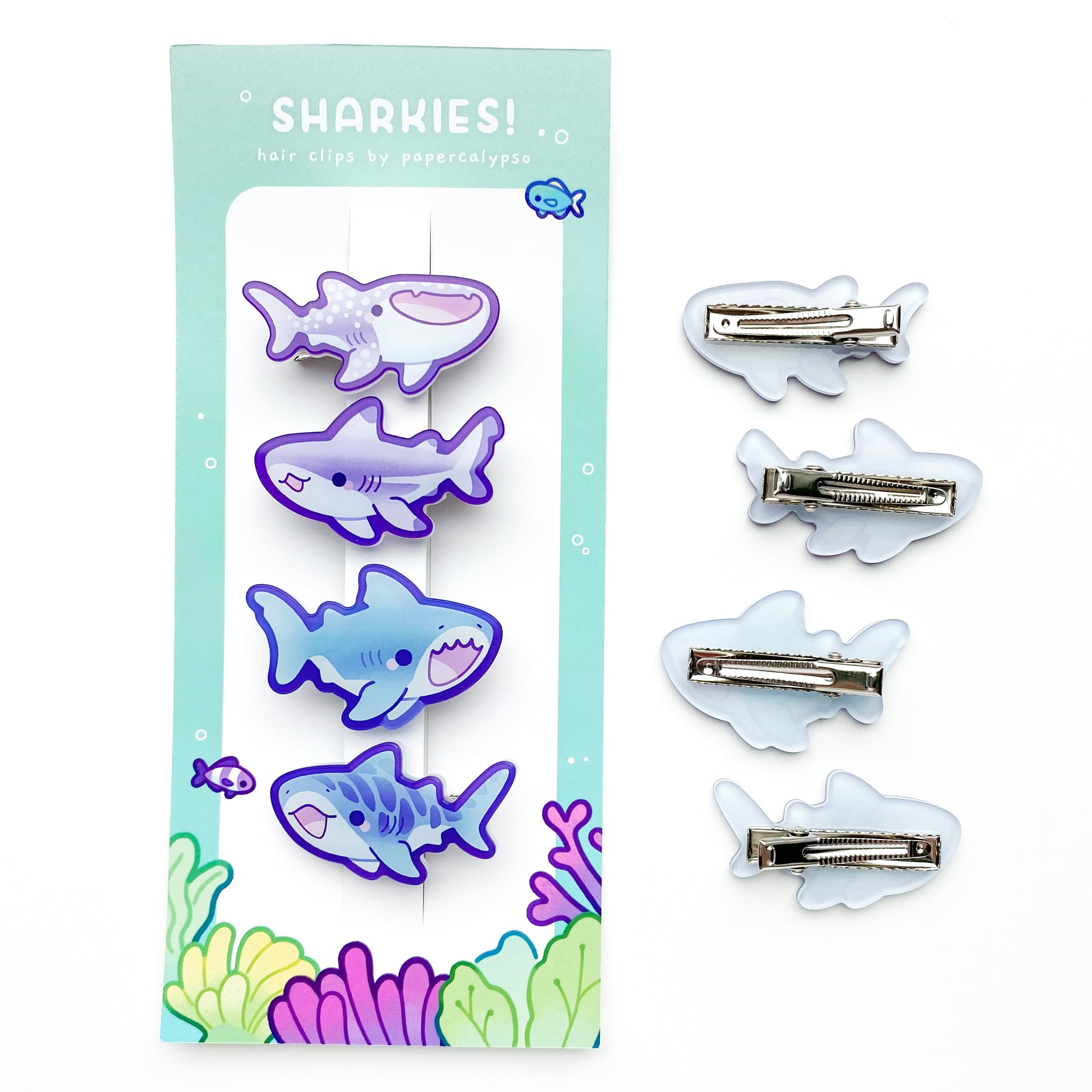 the sharks face away from the face when in your hair. They're presented on a cute coral reef themed backing card.