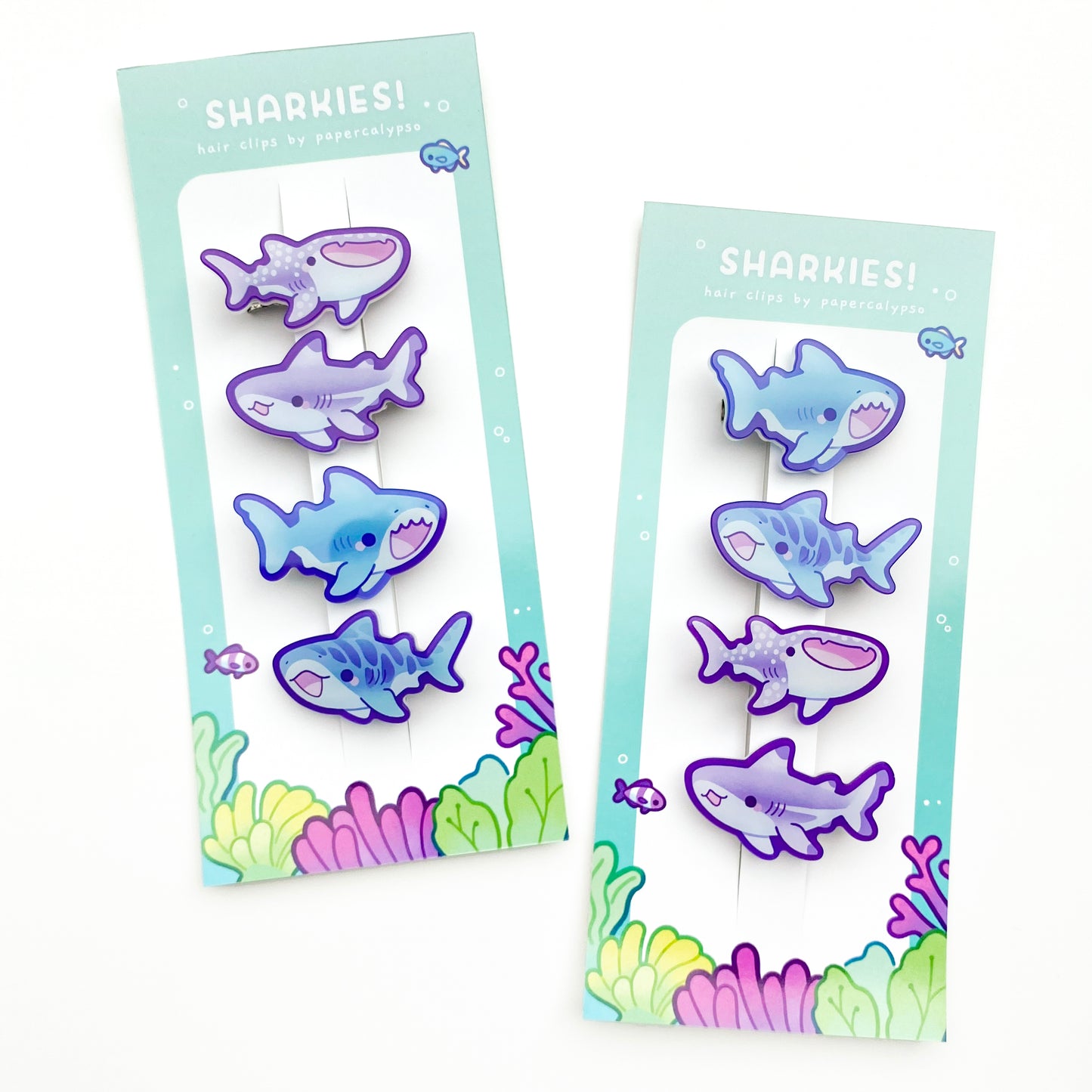 four cute shark hairclips a tiger shark, a great white, a whale shark and a black-tipped reef shark! One purple and one blue set. 