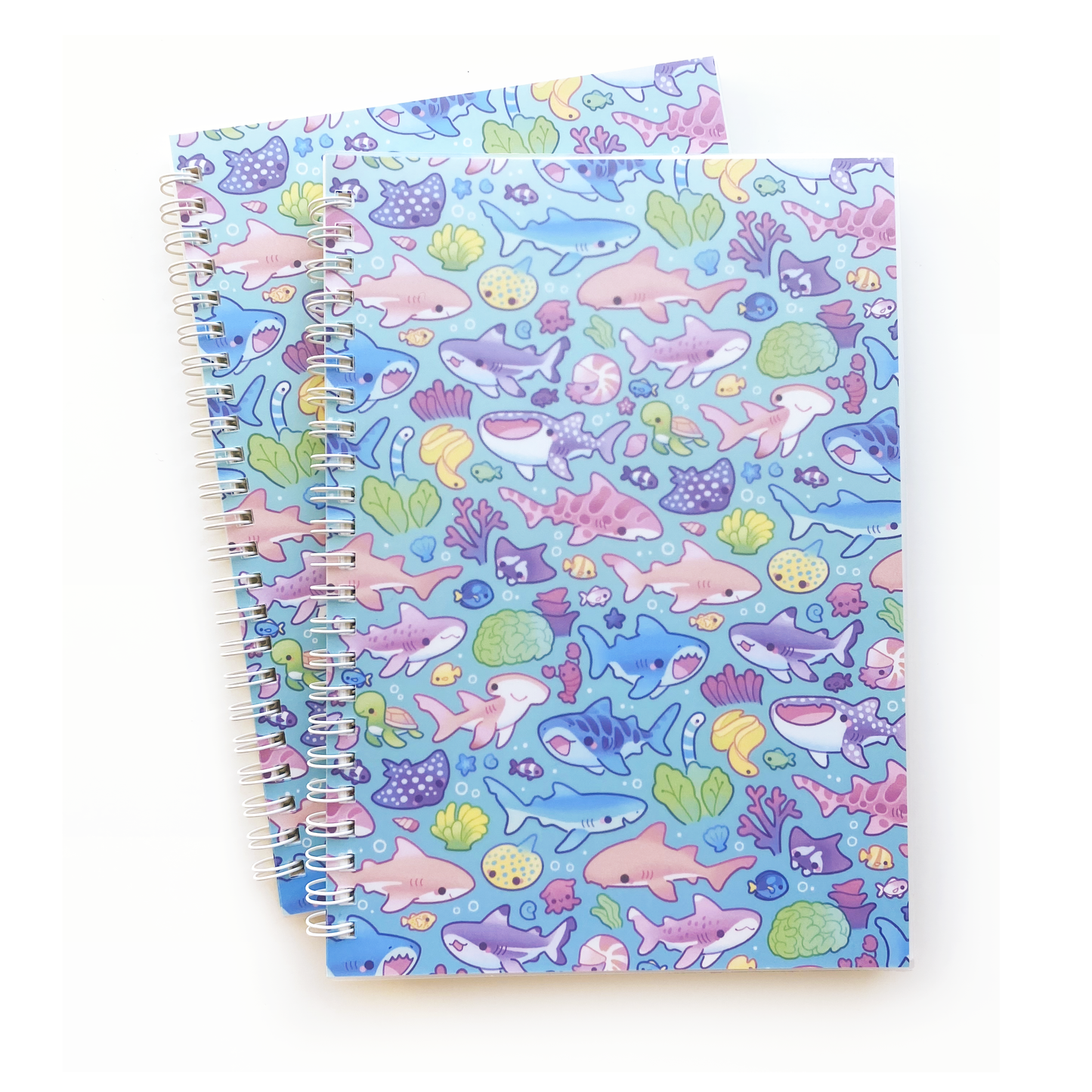 the cover has many different sharks, rays, corals and more! whale shark, blue shark, black-tipped reef shark, great white, tiger shark, nurse shark, leopard shark, white-tipped reef shark, hammerhead shark, surgeon fish, lobster, eel, manta ray, spotted ray, dumbo octopus, nautilus, sea turtle.