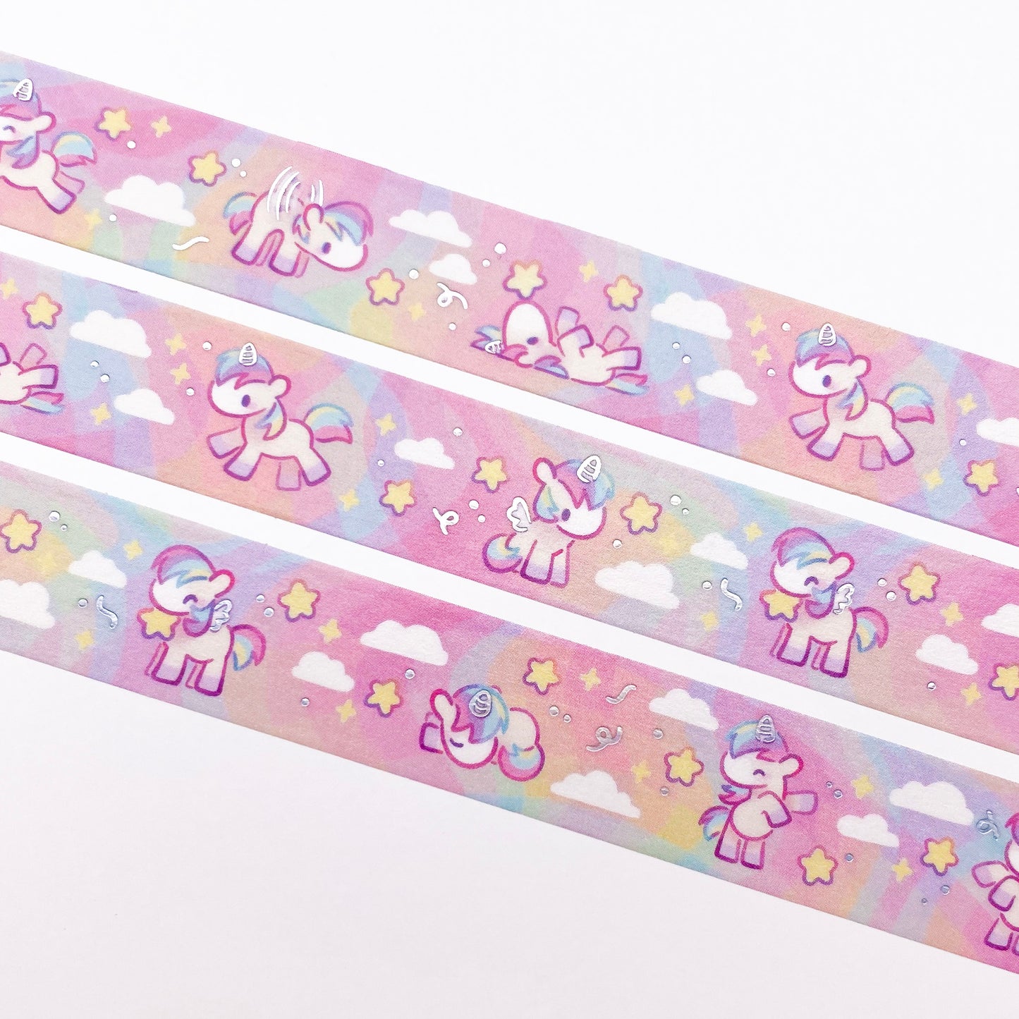 A close-up of the washi tape. The horses are surrounded by chunky, round stars and white fluffy clouds. 