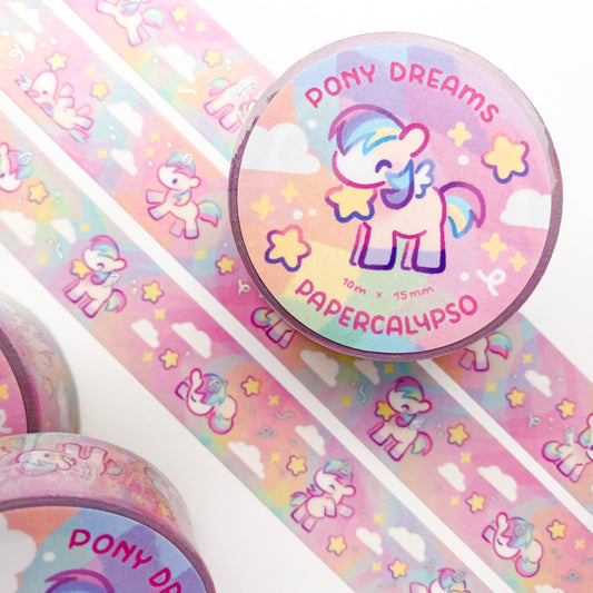 kawaii pony themed washi tape featuring soft cartoon horsies on a pastel rainbow background. The pegasi, unicorns and alicorns are jumping around in the sky, munching on the stars and flying through the clouds.