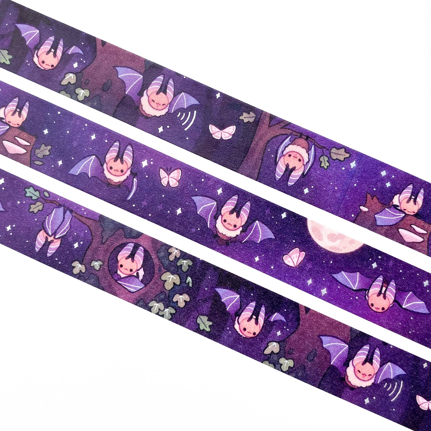 A close-up of the washi tape. The bats are surrounded by stars, moths and a dark oak forest. One is hanging upside down from a branch and another is sleeping on a mushroom-covered tree stump.